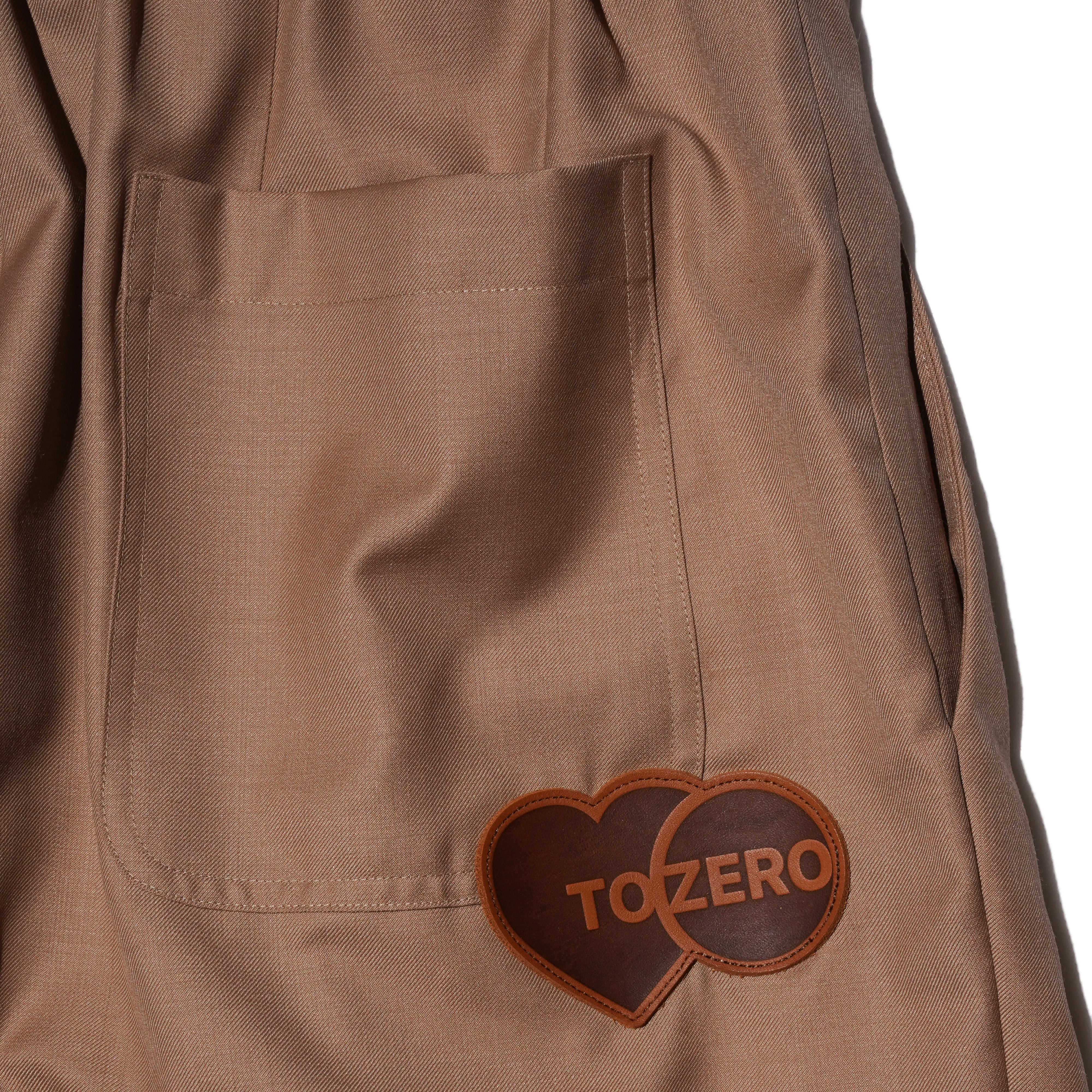 ‘TO ZERO’ Leather Patch Pleated Trousers